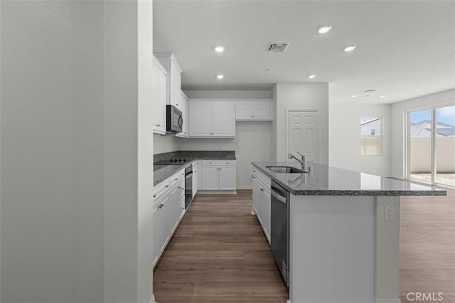 30773 Vera Cruz Cir, Winchester, CA 92596 - kitchen featuring black appliances, dark wood-style floors, white cabinets, a kitchen island with sink, and recessed lighting