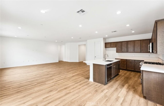 4180 Larchwood Ln, Lake Elsinore, CA 92530 - kitchen with a sink, open floor plan, a center island with sink, dishwasher, and recessed lighting