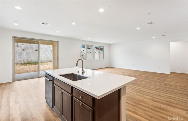 4180 Larchwood Ln, Lake Elsinore, CA 92530 - kitchen featuring a sink, light wood-type flooring, light countertops, recessed lighting, and dark brown cabinetry