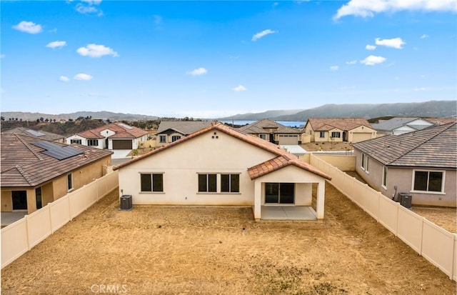 4180 Larchwood Ln, Lake Elsinore, CA 92530 - back of house with a residential view, stucco siding, central AC, and a fenced backyard