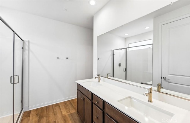 4180 Larchwood Ln, Lake Elsinore, CA 92530 - full bathroom featuring wood finished floors, a shower stall, double vanity, recessed lighting, and baseboards