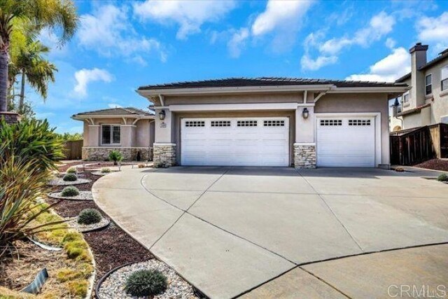 508 Hidden Ridge Ct, Encinitas, CA 92024 - view of front of home with stone siding, driveway, an attached garage, and stucco siding