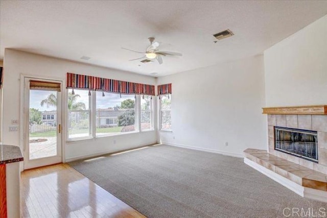 508 Hidden Ridge Ct, Encinitas, CA 92024 - unfurnished living room featuring healthy amount of natural light, ceiling fan, a tile fireplace, and carpet flooring