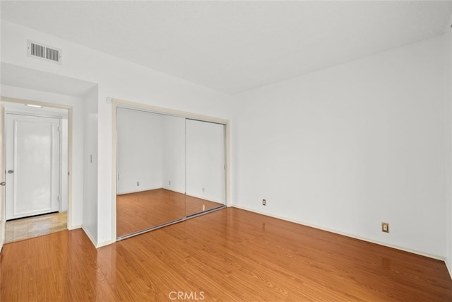10835 Savona Rd, Los Angeles, CA 90077 - unfurnished bedroom with wood finished floors, a closet, and baseboards