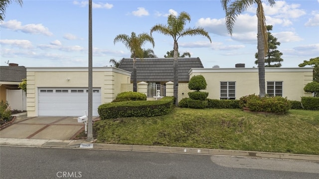 10835 Savona Rd, Los Angeles, CA 90077 - view of front of home featuring an attached garage, stucco siding, and concrete driveway