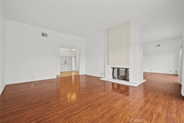 10835 Savona Rd, Los Angeles, CA 90077 - unfurnished living room featuring wood finished floors, a chandelier, and a fireplace