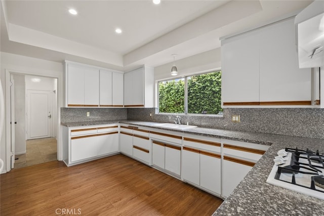 10835 Savona Rd, Los Angeles, CA 90077 - kitchen featuring a sink, white gas cooktop, white cabinetry, wood finished floors, and recessed lighting