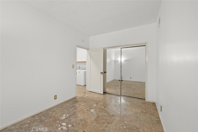 10835 Savona Rd, Los Angeles, CA 90077 - unfurnished bedroom with washer / dryer, a closet, and a textured ceiling