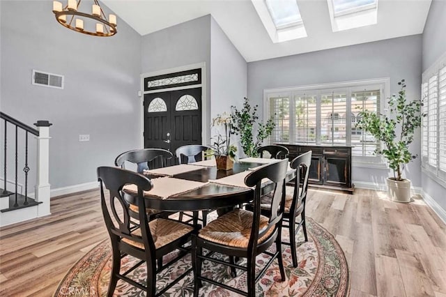 21772 Windsong Cir, Huntington Beach, CA 92646 - dining space with light wood finished floors, stairway, baseboards, high vaulted ceiling, and a chandelier