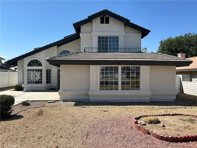 12930 Norfolk Ln, Victorville, CA 92395 - view of front of home with stucco siding, a patio, and a balcony