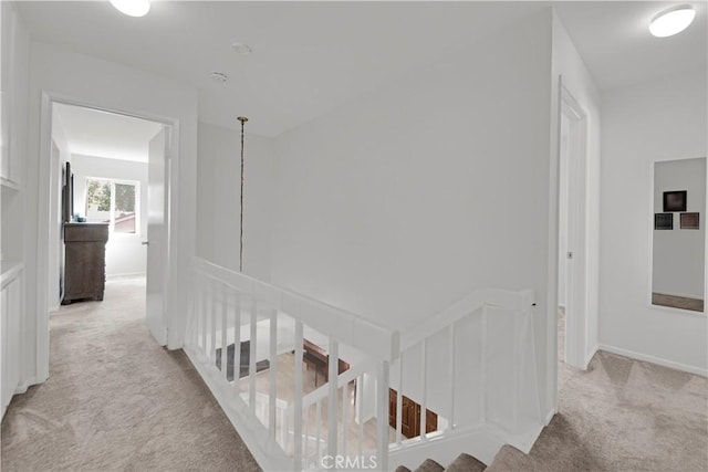23706 Mill Valley Rd, Valencia, CA 91355 - hallway with light colored carpet, an upstairs landing, and baseboards