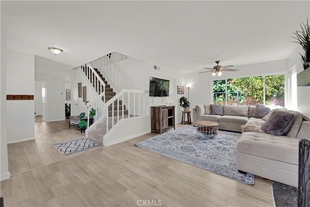 23706 Mill Valley Rd, Valencia, CA 91355 - living area with stairs, a ceiling fan, wood finished floors, and baseboards