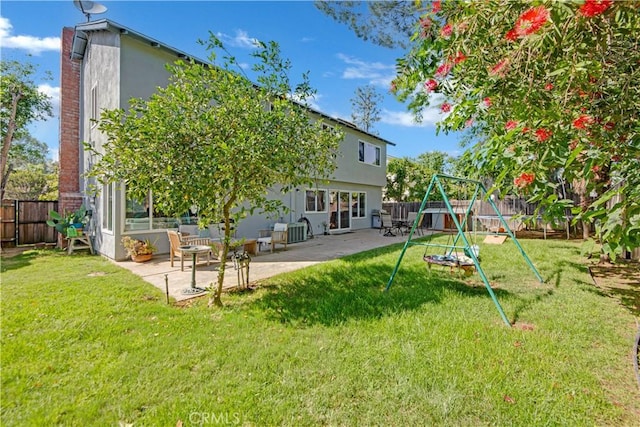 23706 Mill Valley Rd, Valencia, CA 91355 - rear view of house with a playground, stucco siding, a patio, and a chimney