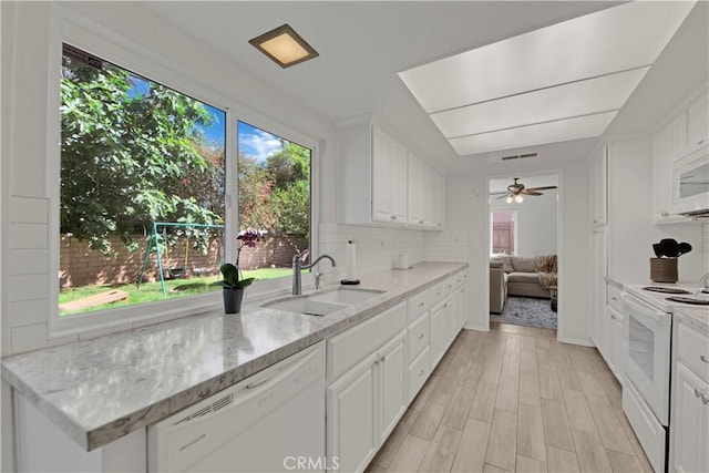 23706 Mill Valley Rd, Valencia, CA 91355 - kitchen with white appliances, a sink, healthy amount of natural light, and white cabinets