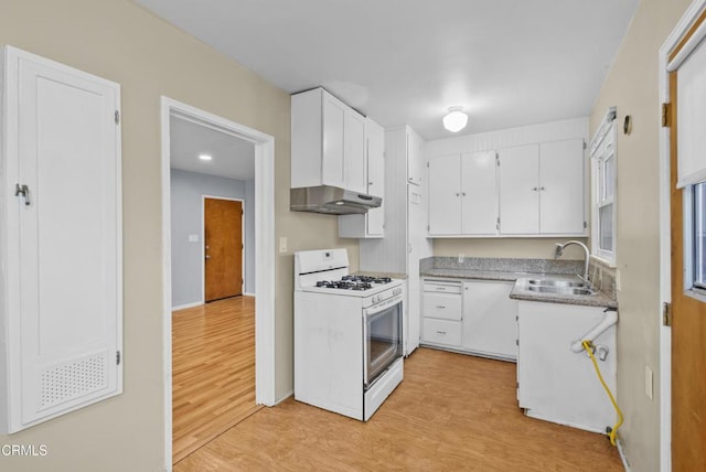 kitchen with white gas range, a sink, light wood-style floors, and white cabinetry