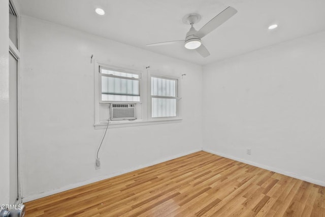 spare room with light wood-style flooring, cooling unit, a ceiling fan, baseboards, and recessed lighting