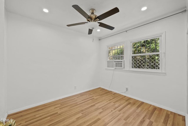 empty room with light wood-style floors, recessed lighting, baseboards, ceiling fan, and cooling unit