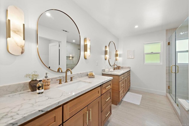 24235 Via Aquara Ave, Laguna Niguel, CA 92677 - bathroom with a stall shower, two vanities, wood finished floors, baseboards, and recessed lighting