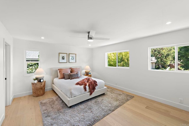 24235 Via Aquara Ave, Laguna Niguel, CA 92677 - bedroom with multiple windows, baseboards, light wood-style floors, recessed lighting, and ceiling fan