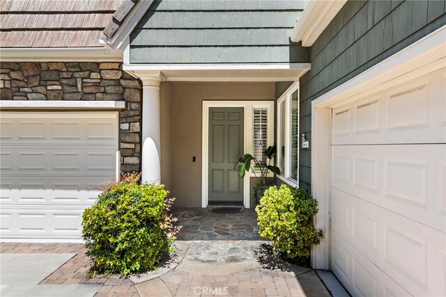 43 Flintridge, Ladera Ranch, CA 92694 - doorway to property featuring stone siding and stucco siding
