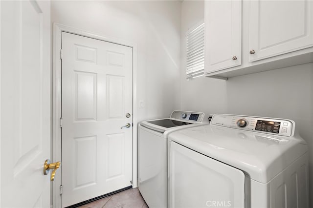 43 Flintridge, Ladera Ranch, CA 92694 - laundry area featuring washing machine and dryer, cabinet space, and light tile patterned flooring