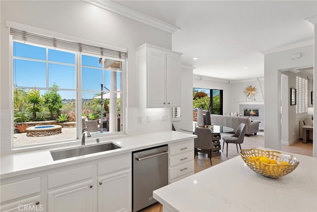 43 Flintridge, Ladera Ranch, CA 92694 - kitchen with stainless steel dishwasher, crown molding, a sink, light countertops, and tasteful backsplash