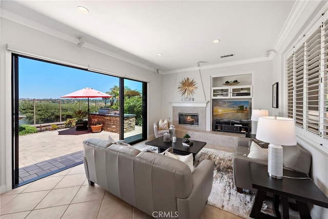43 Flintridge, Ladera Ranch, CA 92694 - living area featuring tile patterned floors, ornamental molding, a high end fireplace, recessed lighting, and built in shelves