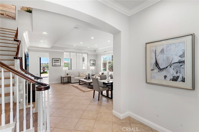 43 Flintridge, Ladera Ranch, CA 92694 - hallway featuring light tile patterned floors, baseboards, healthy amount of natural light, crown molding, and stairway