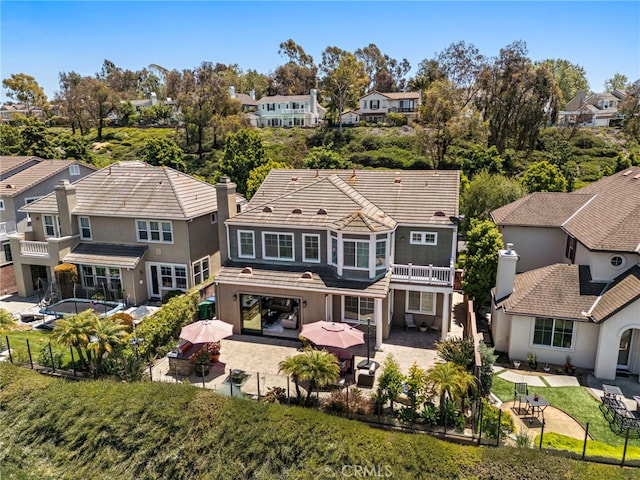 43 Flintridge, Ladera Ranch, CA 92694 - rear view of house featuring a residential view, a patio, a fenced backyard, stucco siding, and a balcony
