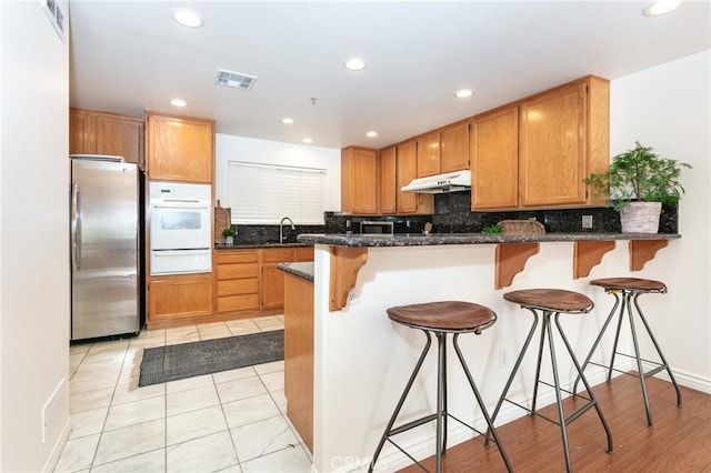 18 Fano St Unit 2, Arcadia, CA 91006 - kitchen featuring oven, stainless steel fridge, under cabinet range hood, a warming drawer, and a sink