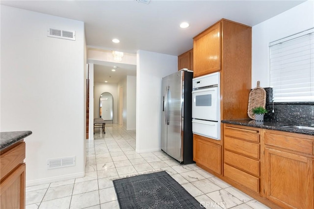 18 Fano St Unit 2, Arcadia, CA 91006 - kitchen featuring stainless steel fridge with ice dispenser, white oven, a warming drawer, arched walkways, and recessed lighting
