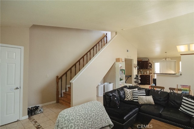 310 Buena Vista Ct, Merced, CA 95348 - living area featuring stairway, tile patterned floors, baseboards, and lofted ceiling