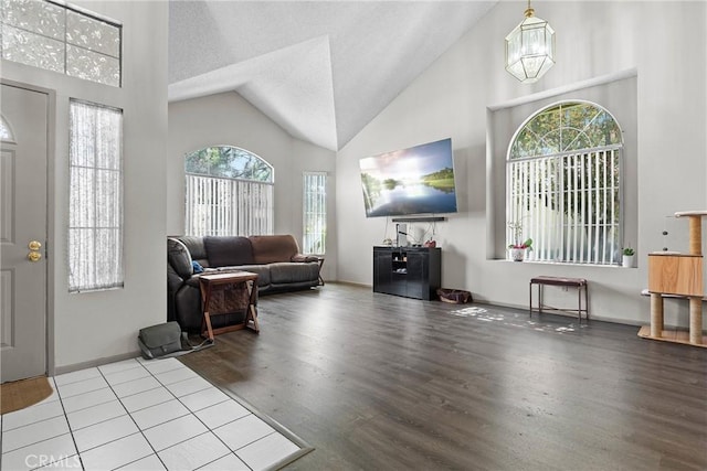 4856 W Glen Abbey Way, Banning, CA 92220 - entryway with high vaulted ceiling, a chandelier, wood finished floors, and baseboards