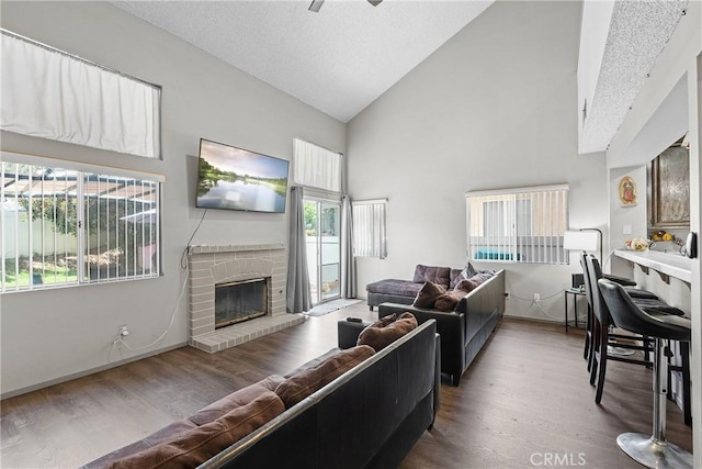 4856 W Glen Abbey Way, Banning, CA 92220 - living room featuring high vaulted ceiling, a fireplace, wood finished floors, and baseboards