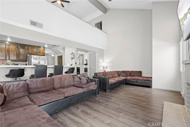 4856 W Glen Abbey Way, Banning, CA 92220 - living room featuring high vaulted ceiling, light wood finished floors, beam ceiling, a brick fireplace, and a ceiling fan