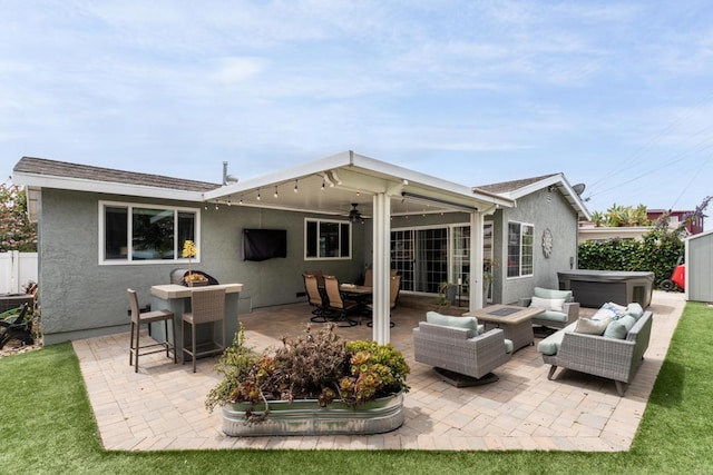 3696 Ben St, San Diego, CA 92111 - rear view of property featuring stucco siding, a hot tub, an outdoor living space, a ceiling fan, and a patio area