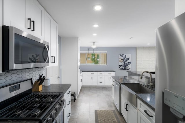3696 Ben St, San Diego, CA 92111 - kitchen featuring stainless steel appliances, a sink, tasteful backsplash, dark stone countertops, and recessed lighting
