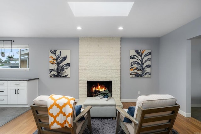 3696 Ben St, San Diego, CA 92111 - living area featuring a brick fireplace, wood finished floors, recessed lighting, a skylight, and baseboards