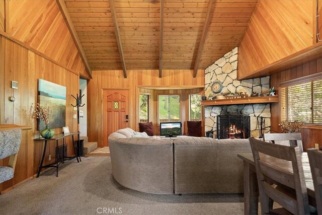 267 Pioneer Rd, Lake Arrowhead, CA 92317 - living room featuring wood walls, wood ceiling with exposed beams, a stone fireplace, carpet, and high vaulted ceiling
