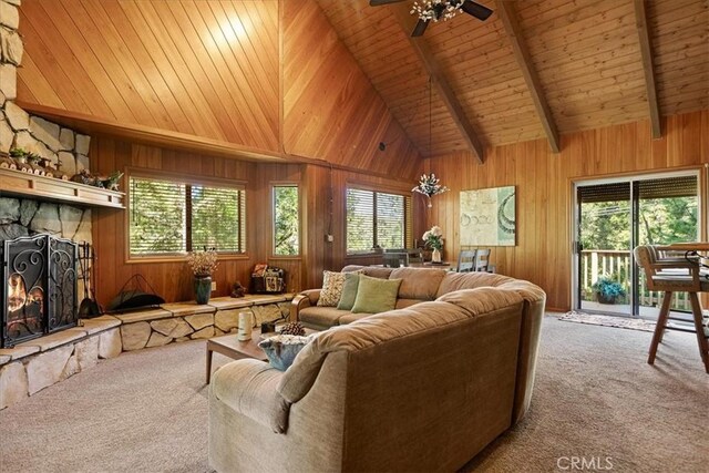 267 Pioneer Rd, Lake Arrowhead, CA 92317 - living room featuring carpet floors, plenty of natural light, a stone fireplace, wood walls, and ceiling fan