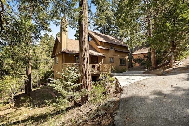 267 Pioneer Rd, Lake Arrowhead, CA 92317 - view of home's exterior with a shingled roof and a wooden deck