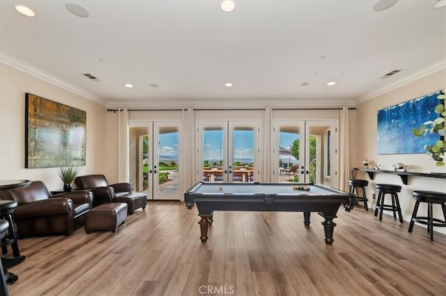 playroom with french doors, billiards table, ornamental molding, light wood finished floors, and plenty of natural light