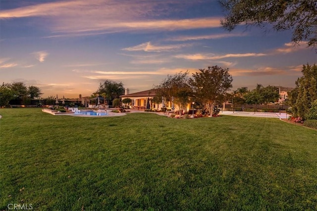 view of green lawn with an outdoor pool