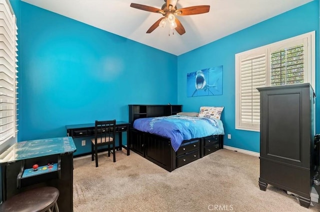 bedroom featuring carpet, baseboards, vaulted ceiling, and a ceiling fan