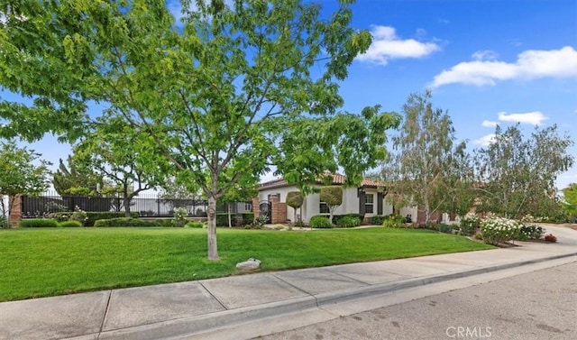 ranch-style home with stucco siding and a tiled roof