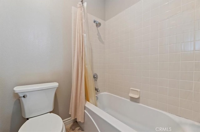 bathroom with toilet and shower / bath combination with curtain