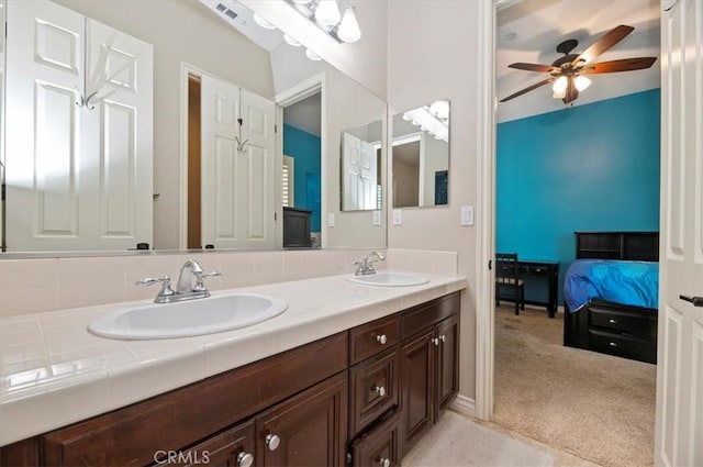 bathroom featuring double vanity, a ceiling fan, and connected bathroom