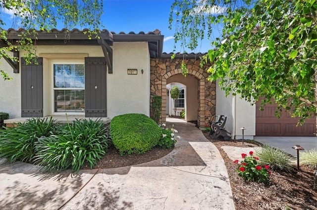 view of front of property with stucco siding, stone siding, and a tiled roof