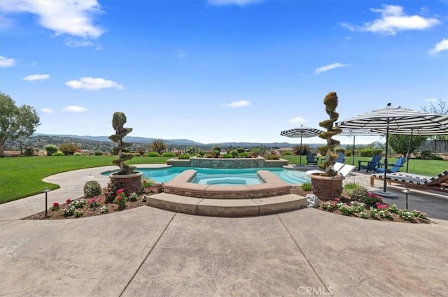 swimming pool featuring a patio area, a mountain view, an in-ground hot tub, and a yard