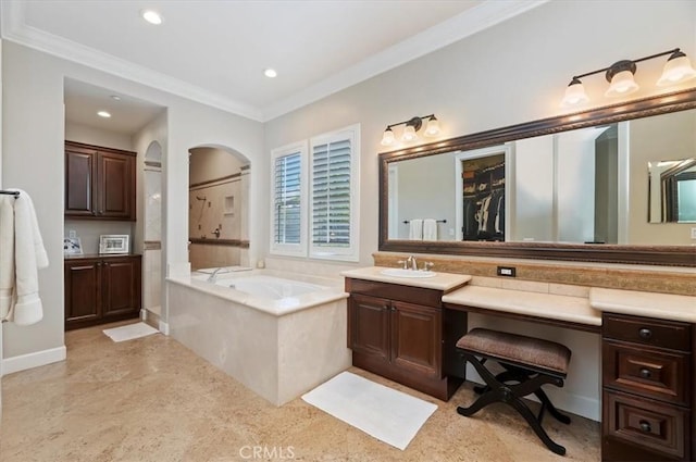 bathroom featuring ornamental molding, vanity, a bath, recessed lighting, and a closet